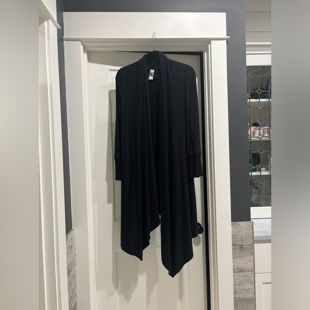 Black knit long sweater with studded angel wings on the back.